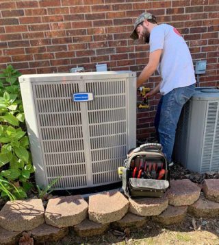 A skilled professional from Seark Heating & Air checks out a customer's HVAC unit